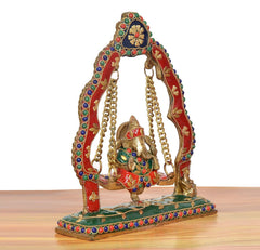 Brass Ganesha swing jhula statue, angled view showing multicolor arch and base details