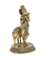 Brass Krishna on cow statue, rear three-quarter view, ornate headdress and flute