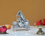 Seated Lord Ganesha statue in brass tone, side view with detailed jewelry and crown
