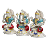 Brass Ganesha idol side view, turquoise tunic and red accents, jeweled crown, seated pose