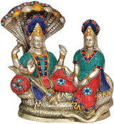 Brass Vishnu Lakshmi idol statue, front view with crown, painted jewelry and teal-red drape
