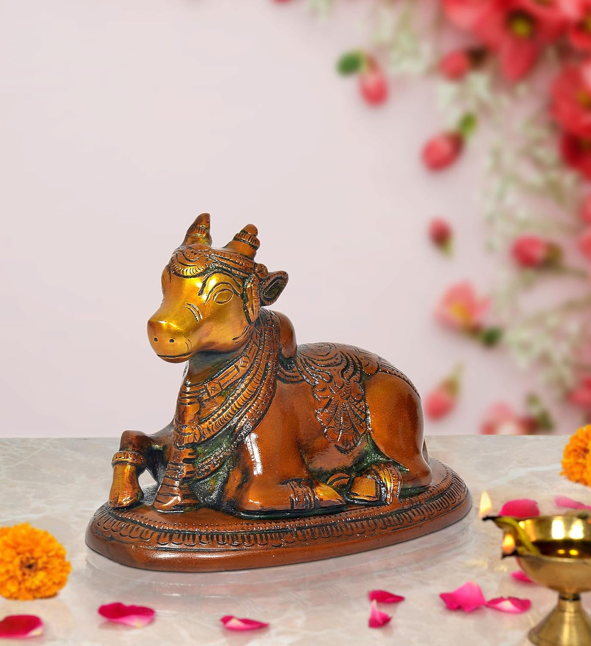 Seated brass Nandi bull statue with ornate chest, head details, and engraved base