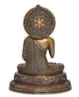 Back view of brass Buddha statue with ornate halo medallion and engraved robe details