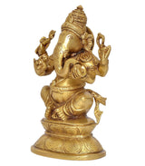 Ganesha statue in brass finish, side view with ornate jewelry and raised hand