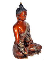 Brass Gautam Buddha idol side view, seated Bhumisparsha pose, golden patterned robe