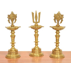 Golden brass oil lamps with shankh diya form and engraved base, three-piece display