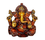Ganesha idol on lotus with raised arms and gold face, red-brown resin finish