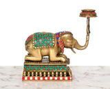 Brass elephant candle stand lamp in side view, patterned saddle and beaded base