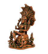 Brass Dakshinamurti Shiva statue side view, orange figure with green accents and base