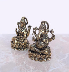 Brass Lakshmi & Ganesha idols from angled side view, seated on lotus bases