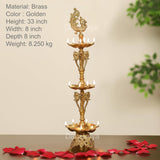 Brass peacock oil lamp stand with three tiers and ornate elephant figures