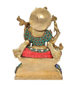 Back view of Saraswati idol seated, round gold backplate and multicolour jewel collar