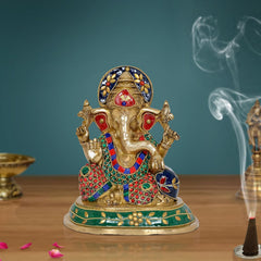 Brass Ganesha religious statue with colorful gemstone-style detailing, raised hands