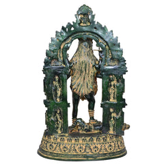 Mahakali Mata brass idol back view, arched halo frame, patterned skirt, green patina