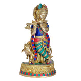 Krishna brass statue on cow base, ornate crown and jewelry, flute pose