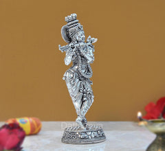 Lord Krishna brass figurine, back-left view with flute held to the side