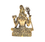 Brass Lord Shiva statue seated, trident staff beside shoulder, left hand holding small drum.
