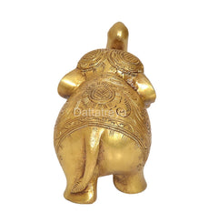 Brass elephant figurine, rear view with raised circular and line patterns
