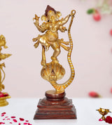 Brass Lord Ganesha dancing on serpent Shesha idol with dark red base and gold detailing