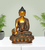 Brass meditating Buddha in dhyan mudra, ornate base with small green figure