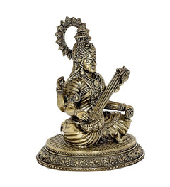Brass Saraswati idol seated with veena, side view, decorative halo and jewelry
