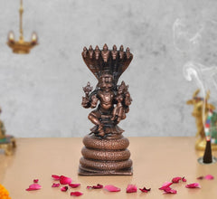 Copper Lakshmi Narasimha idol on pedestal, under Sheshnag hood, front view