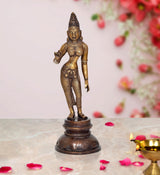 Brass Parvati statue with raised hand, detailed face, and dark circular base