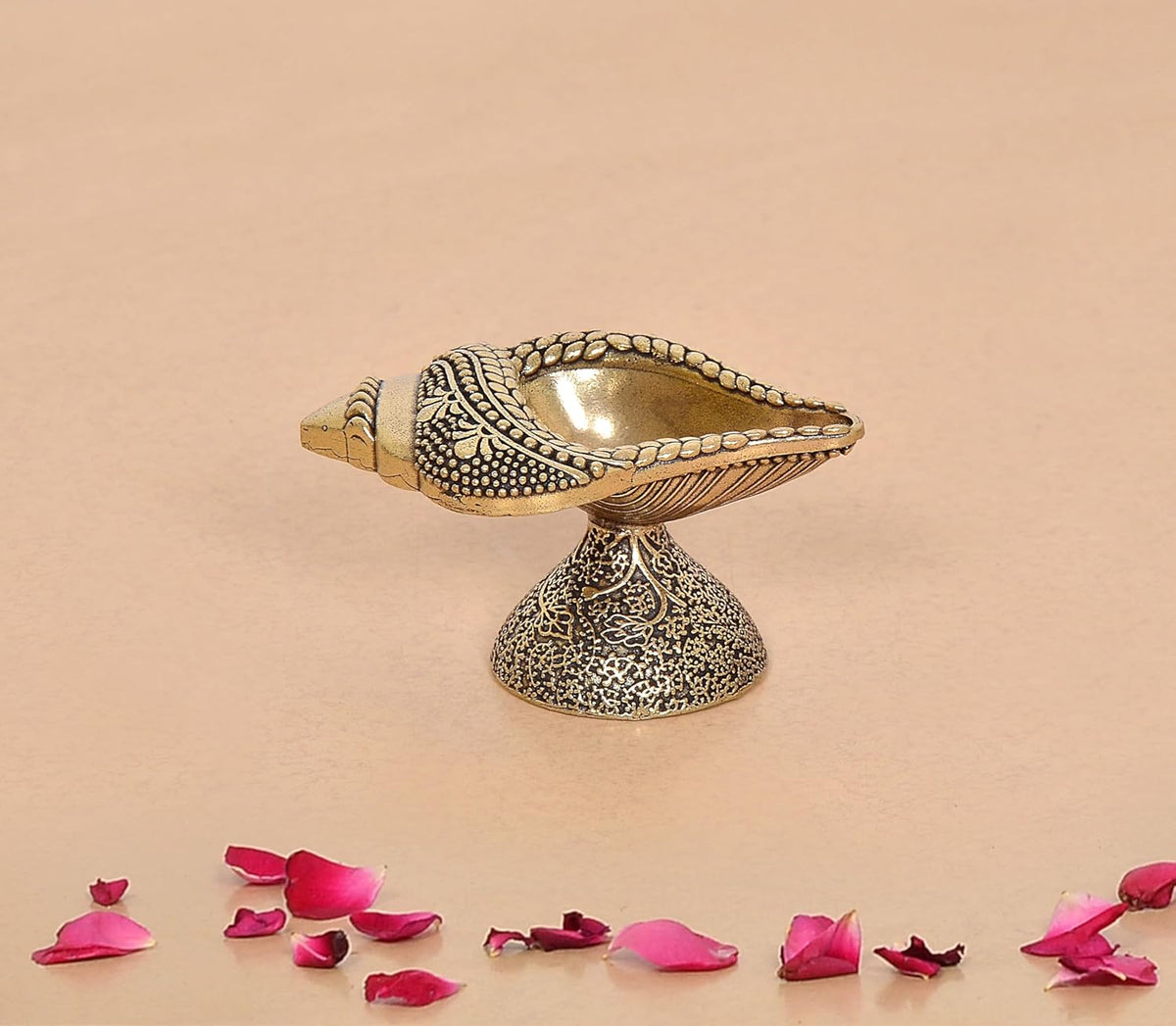Brass conch oil diya lamp with engraved shell bowl on ornate pedestal, bronze tone