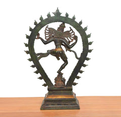 Brass Lord Shiva Natraj dancing idol, dark green patina, circular arch, on pedestal base
