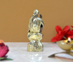Brass Shirdi Sai Baba statue, rear view, seated robes and hands visible