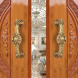 Ornate brass door handle pair, golden finish, decorative lever plate