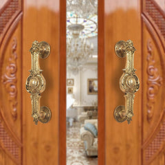 Ornate brass door handle pair, golden finish, decorative lever plate