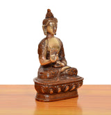 Brass Buddha idol seated, Abhaya mudra, detailed robe and ornate base