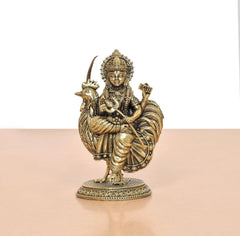 Bronze Bahuchara Mata idol close-up, crowned seated figure holding rooster on base