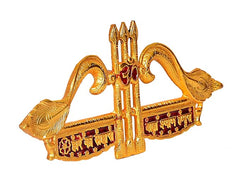 Angle view of golden metal trident wall hanging nishaan with red jewel details