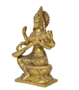 Brass Saraswati idol side view, seated playing veena with ornate hair and jewelry