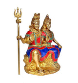 Brass Shiv-Parvati idol with trident, front view, multicolored garments, seated