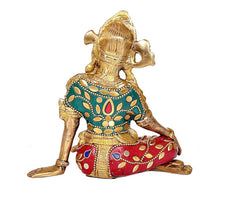 Sitting Indra brass idol rear/side view, teal chest ornaments and red patterned lower garment