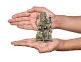 Hand-size brass Lakshmi Narasimha statue (4 inch) held in two hands for scale