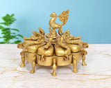 Brass kumkum box with peacock finial and 9-compartment round design