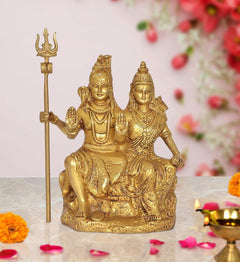 Brass Shiva and Parvati seated showpiece with trident, ornate detailing