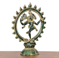 Close side view of dancing Lord Shiva brass idol with green and gold details on base