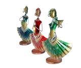 Iron folk musician figurines, angled view: red drummer and green/blue trumpet players