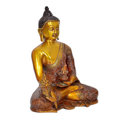 Gold Buddha statue meditating, three-quarter view, brown robe with embossed patterns