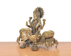 Lakshmi Maa idol side view, seated posture with draped garment and jeweled arms