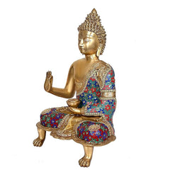 Brass Buddha idol seated side view, raised blessing hand, multicolor beaded robe
