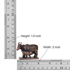 Copper cow and calf statue (height 1.5 in), shows size on measuring rulers