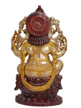 Back view of seated Ganesha idol with dark red halo and gold-tone ornaments