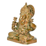 Close view of brass Ganesha idol head with crown details and halo backplate