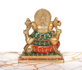 Back view of seated Ganesha brass idol with multicolor garment accents and fan-like halo